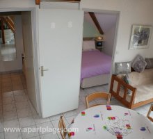 View of main living space towards main bedroom from the staircase, apartplage